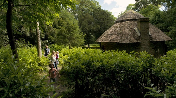 1067307_family walking through bathways between laurel brushes